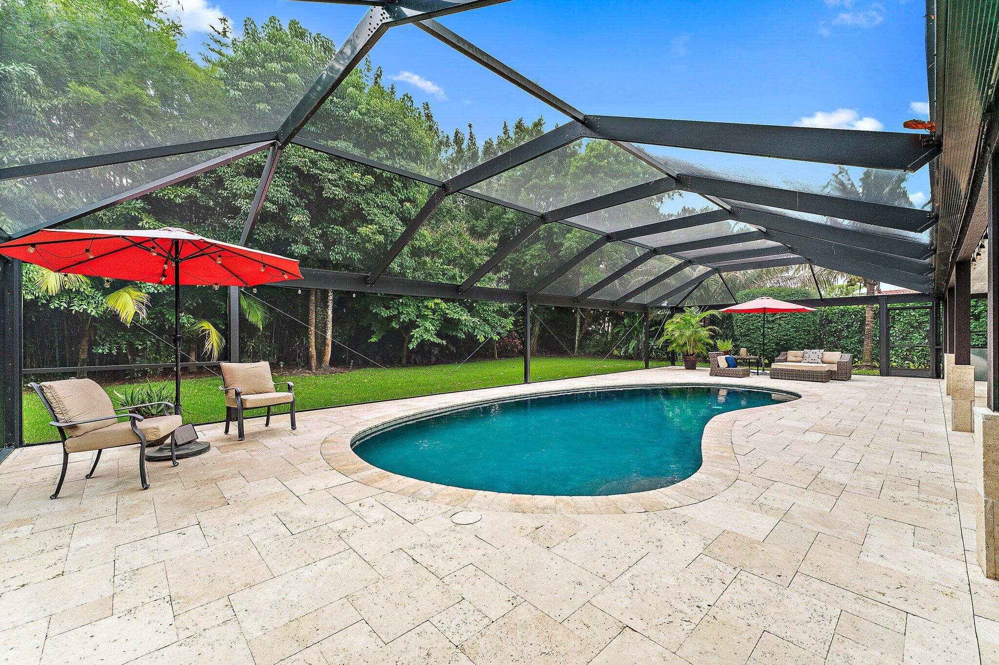 19546 Red Gum Trail Jupiter, FL 33458 - Photo 37 of 42 a view of pool with lawn chairs under an umbrella
