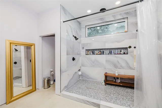 a bathroom with a tub and shower