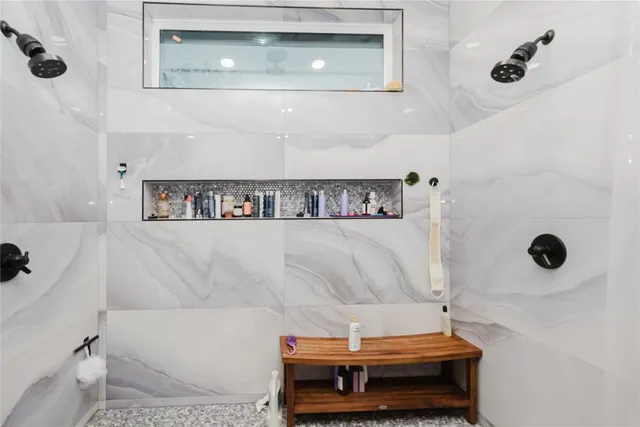 a bathroom with a bathtub and shower