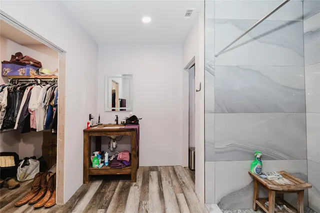 a view of bathroom with a sink mirror and window