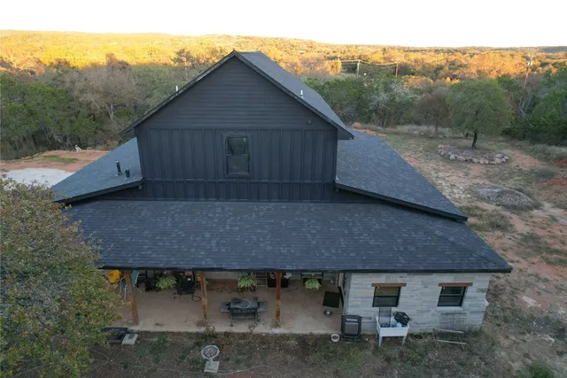 a aerial view of a house with a yard and garage
