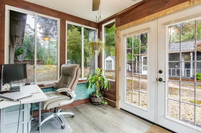 a view of a wooden chairs and bench in the balcony
