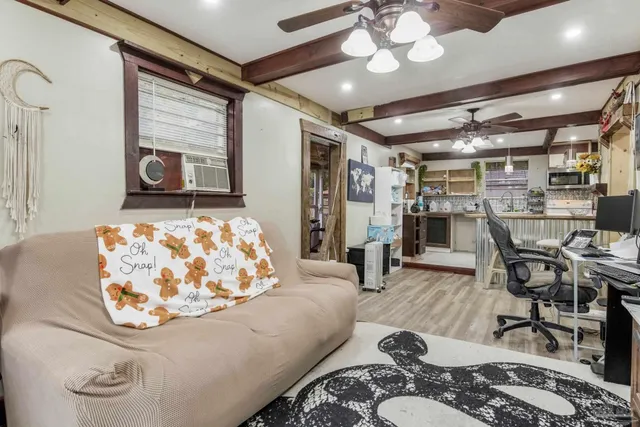 a bedroom with a bed and a flat tv screen on dresser