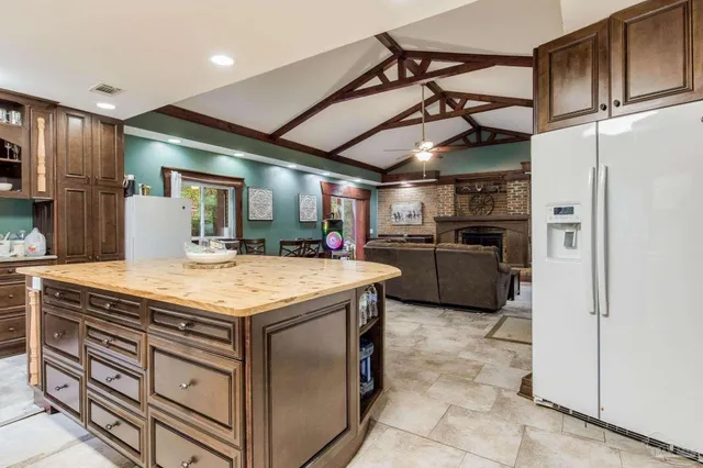 a kitchen with stainless steel appliances granite countertop a sink a stove and a refrigerator