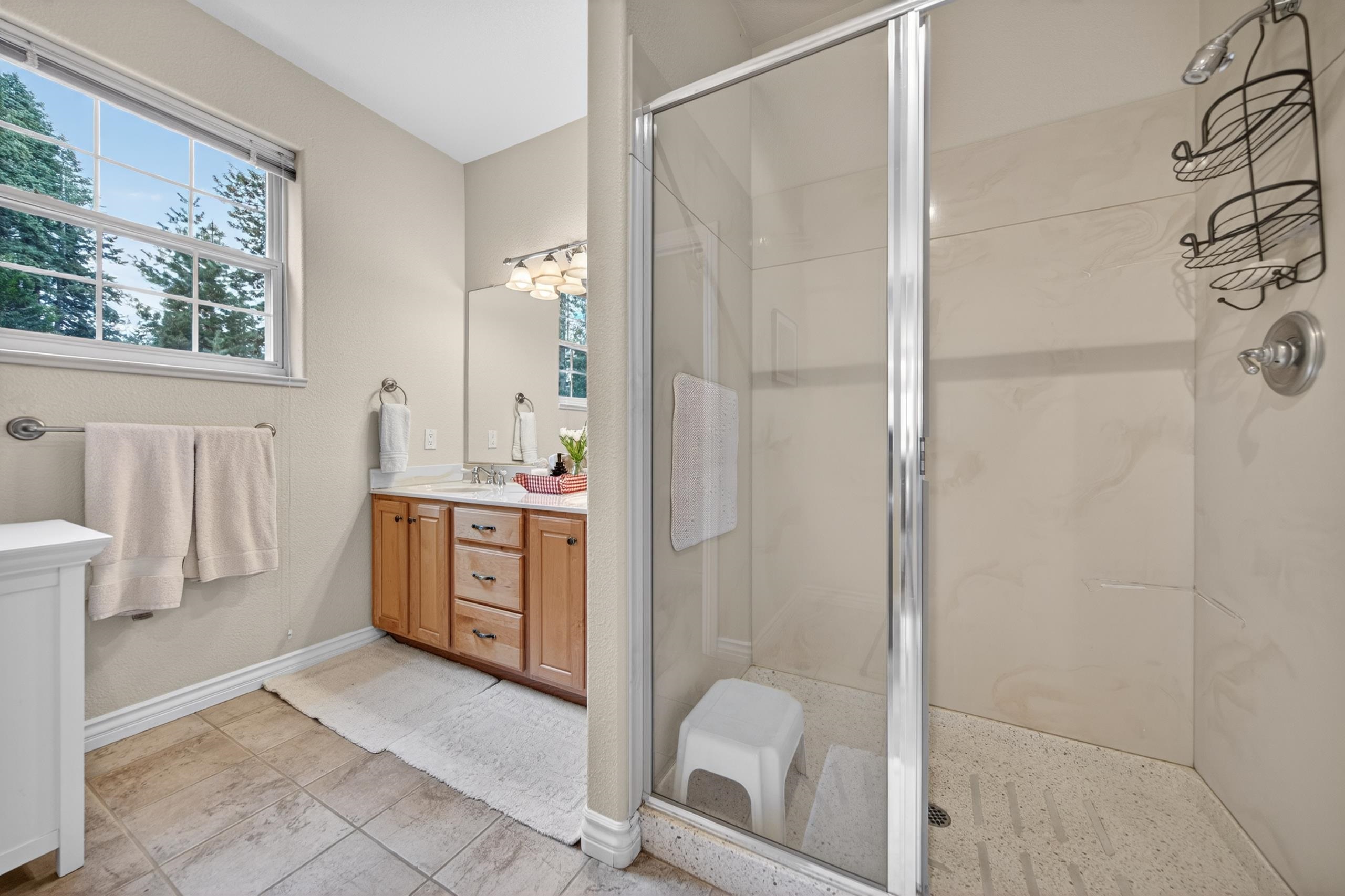 1017 Timber Ridge Road Lake Almanor, CA 96137 - Photo 20 of 45 a bathroom with a double vanity sink toilet and shower