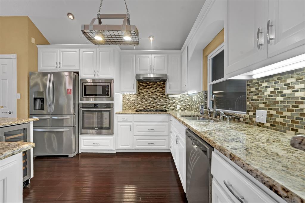 3410 Ridge Oak Drive Garland, TX 75044 - Photo 11 of 29 a kitchen with stainless steel appliances kitchen island granite countertop a refrigerator and microwave