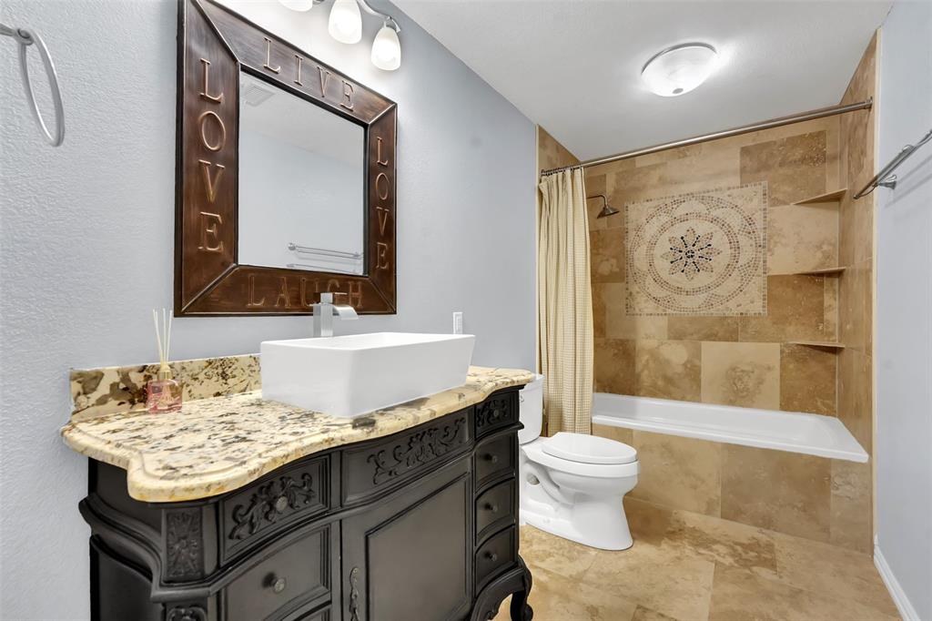 3410 Ridge Oak Drive Garland, TX 75044 - Photo 14 of 29 a bathroom with a sink and a mirror