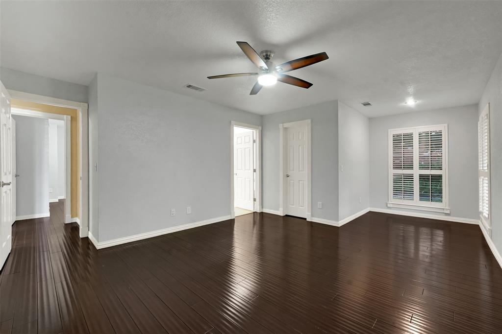 3410 Ridge Oak Drive Garland, TX 75044 - Photo 18 of 29 a view of an empty room with wooden floor and a window