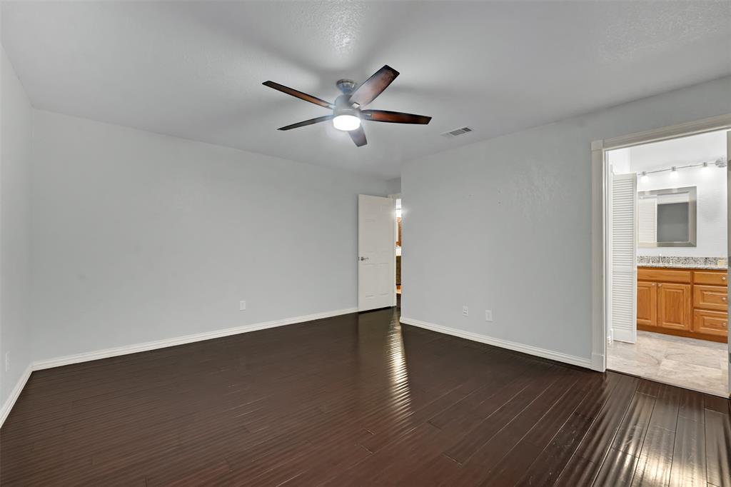3410 Ridge Oak Drive Garland, TX 75044 - Photo 19 of 29 a view of an empty room with window and wooden floor