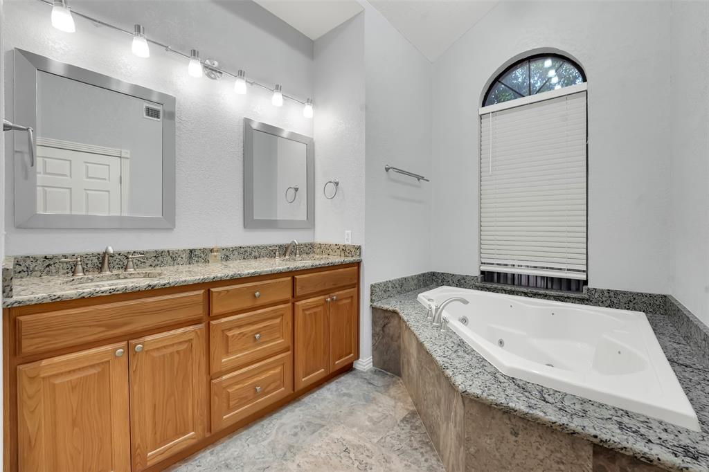 3410 Ridge Oak Drive Garland, TX 75044 - Photo 20 of 29 a bathroom with a granite countertop tub sink and mirror