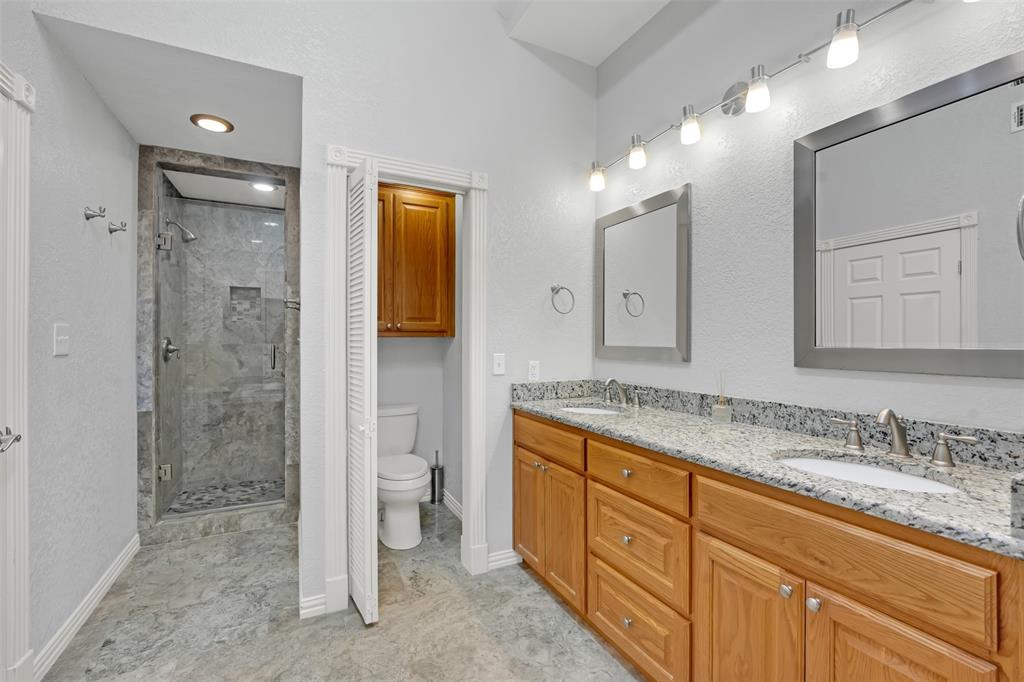 3410 Ridge Oak Drive Garland, TX 75044 - Photo 21 of 29 a spacious bathroom with a granite countertop sink mirror and shower