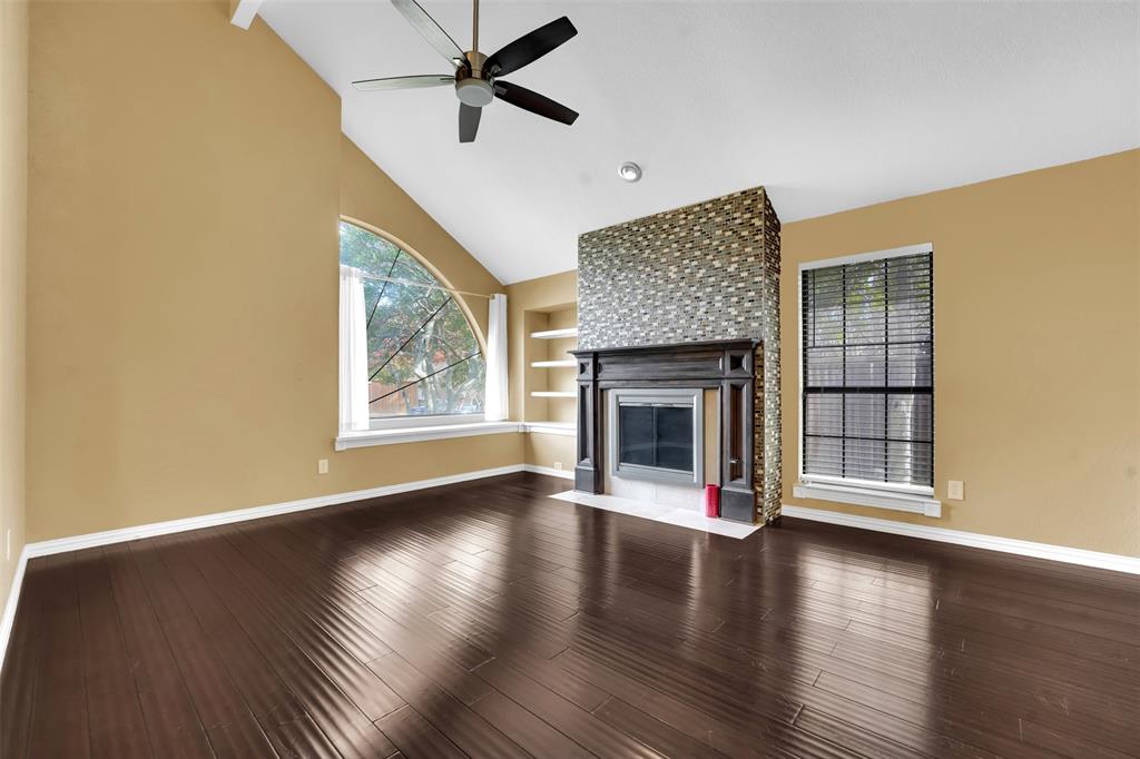 3410 Ridge Oak Drive Garland, TX 75044 - Photo 4 of 29 a view of an empty room with wooden floor fireplace and a window
