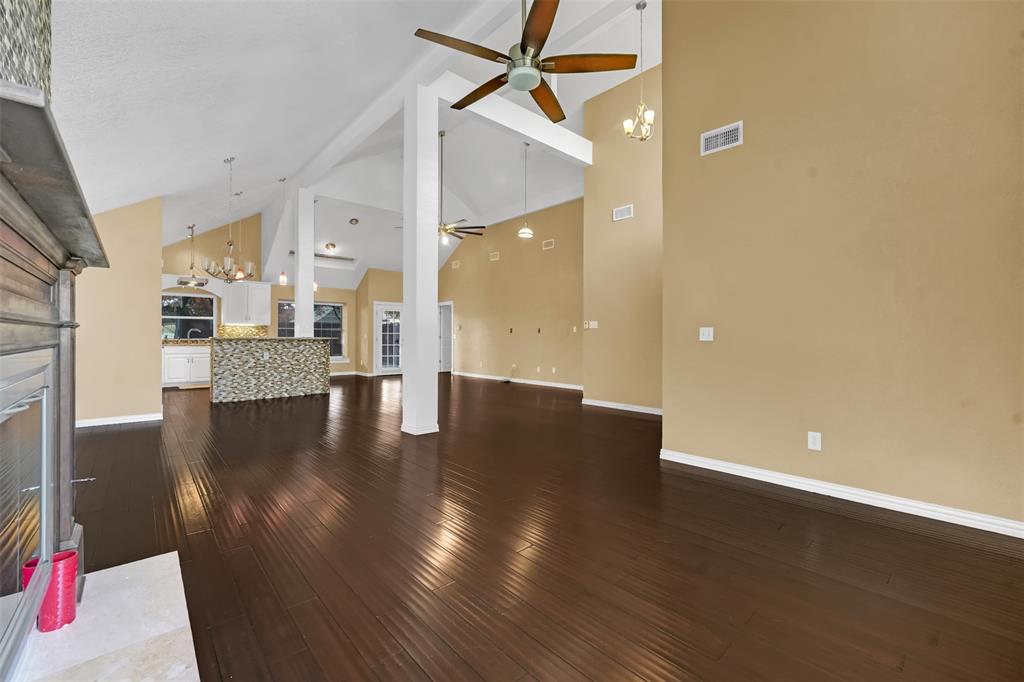 3410 Ridge Oak Drive Garland, TX 75044 - Photo 5 of 29 a view of a kitchen with a fridge and wooden floor