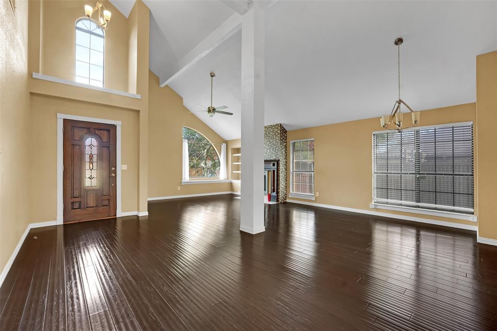 3410 Ridge Oak Drive Garland, TX 75044 - Photo 7 of 29 a view of an empty room with wooden floor and a window
