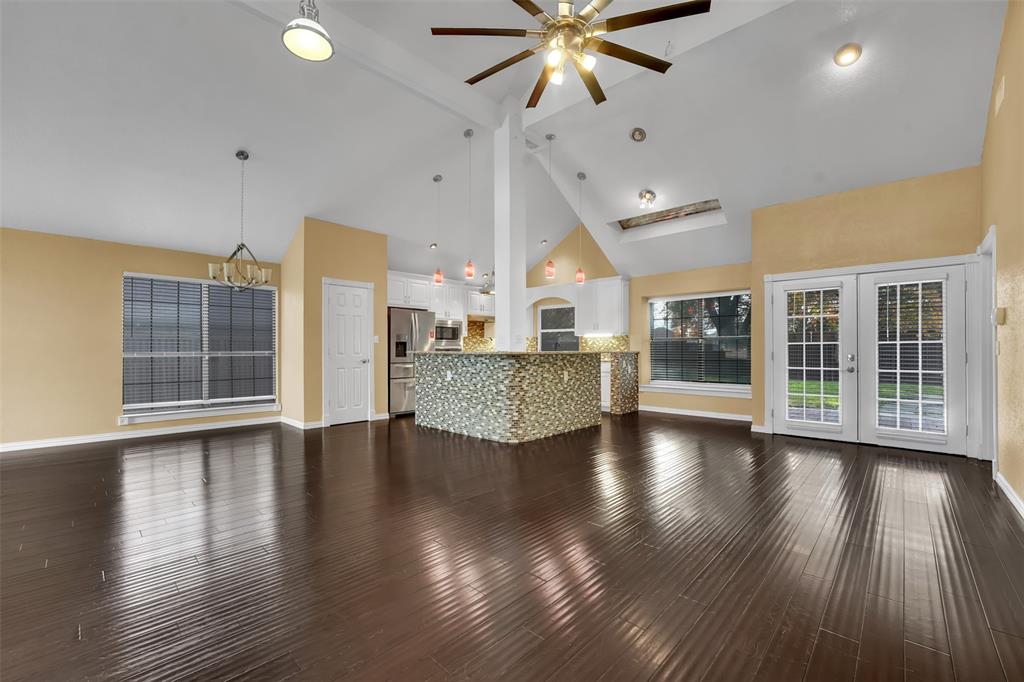 3410 Ridge Oak Drive Garland, TX 75044 - Photo 8 of 29 an empty room with wooden floor and windows