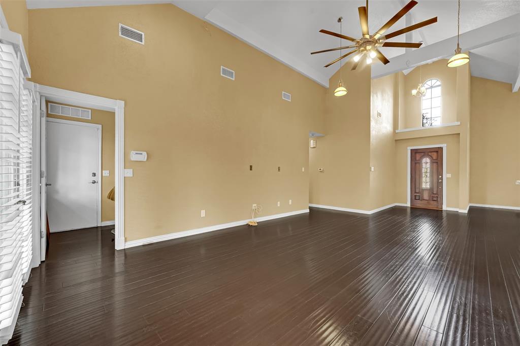 3410 Ridge Oak Drive Garland, TX 75044 - Photo 10 of 29 a view of an empty room with wooden floor and a window
