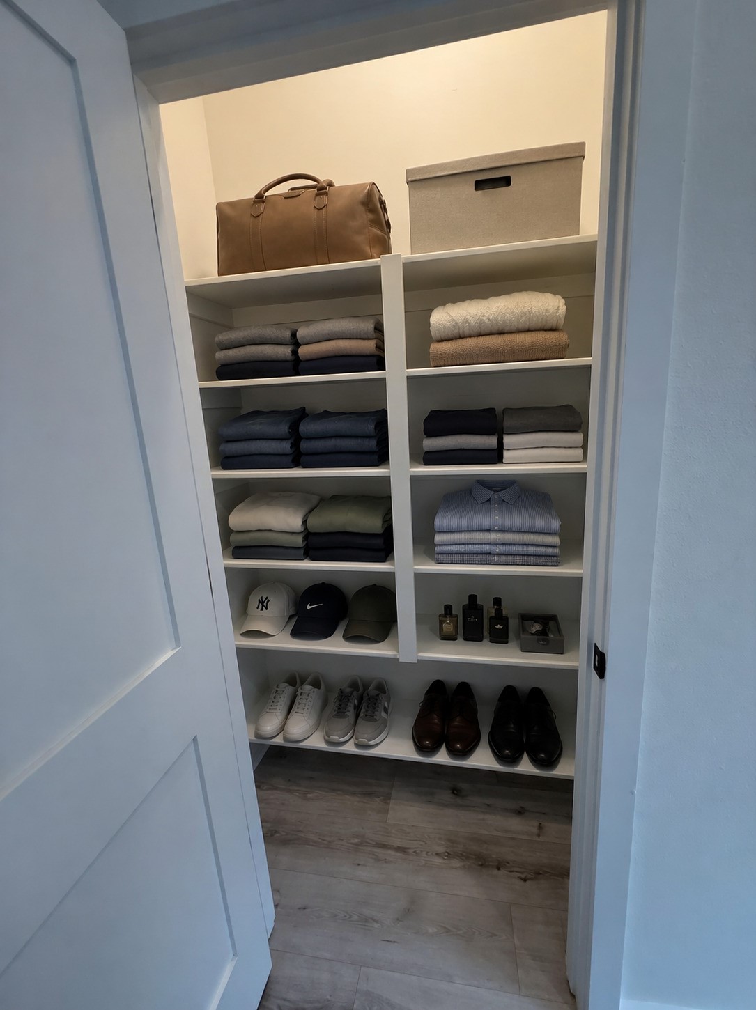 2000 Riverside Farms Road, Unit 19102 Austin, TX 78741 - Photo 12 of 13 This photo shows a well-organized walk-in closet with neatly arranged shelves. It includes folded clothes, shoes, hats, and accessories, offering ample storage space and a tidy layout.