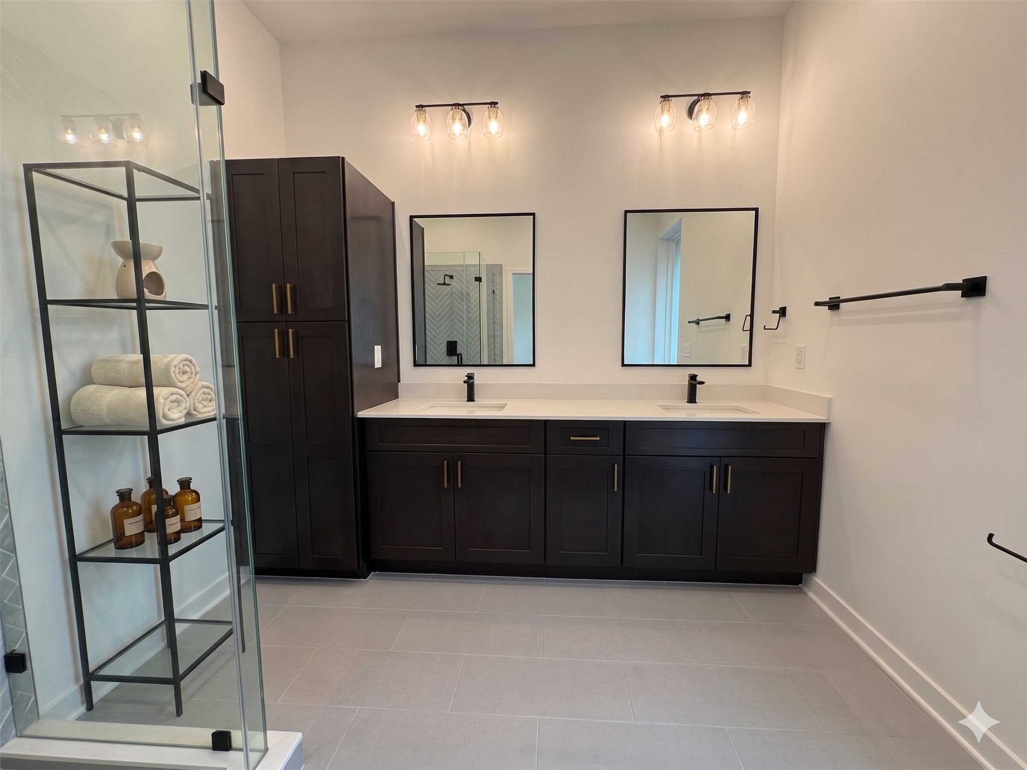 2000 Riverside Farms Road, Unit 19102 Austin, TX 78741 - Photo 6 of 13 This modern bathroom features a double vanity with dark wood cabinets, sleek black fixtures, and elegant lighting. It includes a glass-enclosed shower and open shelving for storage, creating a stylish and functional space.
