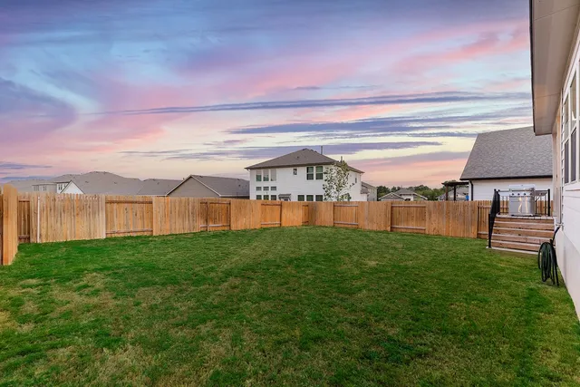 a view of yard with swimming pool and green space