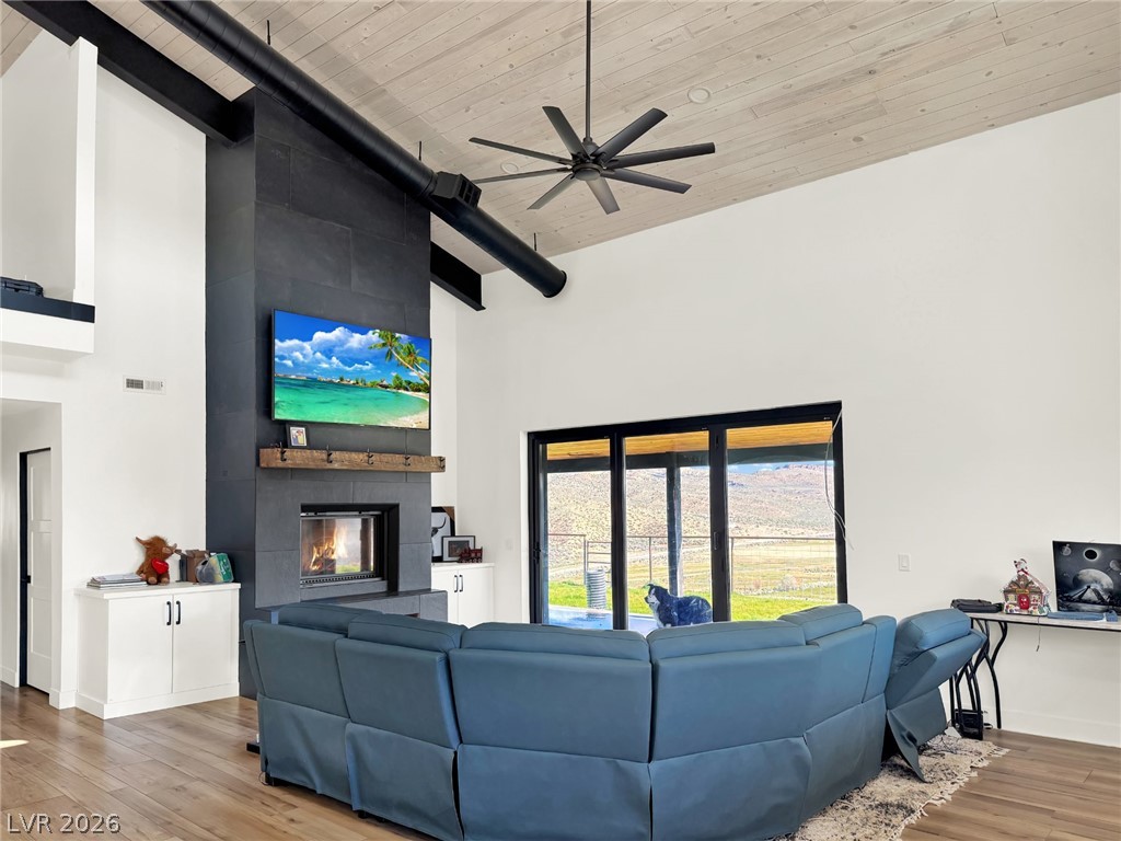 9393 North 93rd Highway Caliente, NV 89008 - Photo 29 of 41 Dramatic vaulted ceilings crown this airy great room, offering warmth from the fireplace and picturesque outdoor views.