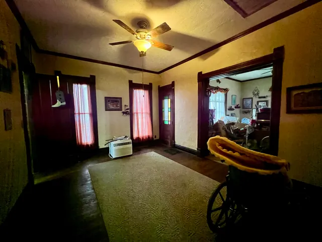 a view of a livingroom with furniture and a ceiling fan