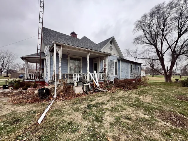 a view of a house with backyard porch and sitting area