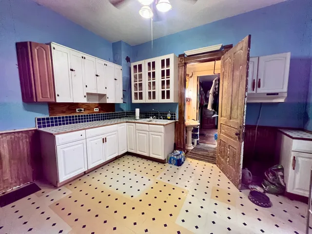 a kitchen with a sink a stove and cabinets