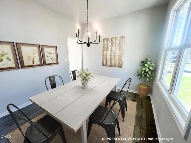 a view of a dining room with furniture and window