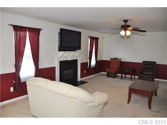 232 Royalton Road Mooresville, NC 28115 - Photo 5 of 16 a living room with furniture a flat screen tv and a window