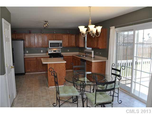 232 Royalton Road Mooresville, NC 28115 - Photo 6 of 16 a kitchen with kitchen island granite countertop furniture a window and stainless steel appliances