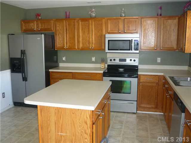 232 Royalton Road Mooresville, NC 28115 - Photo 7 of 16 a kitchen with stainless steel appliances a stove microwave and refrigerator