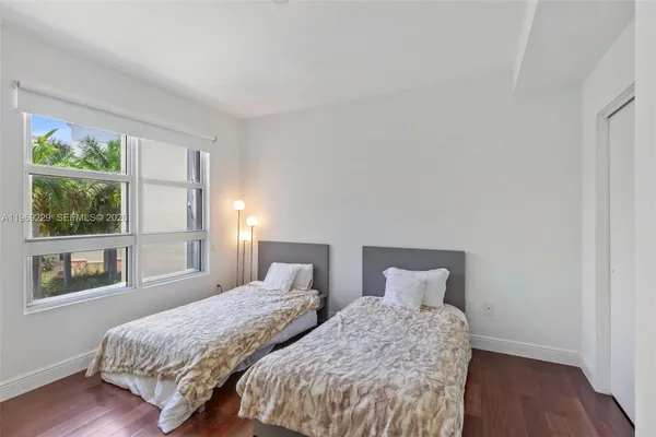 a bedroom with two beds and a window
