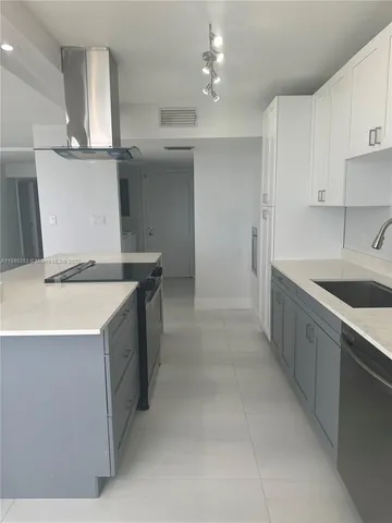 a kitchen that has a sink and a stove in it