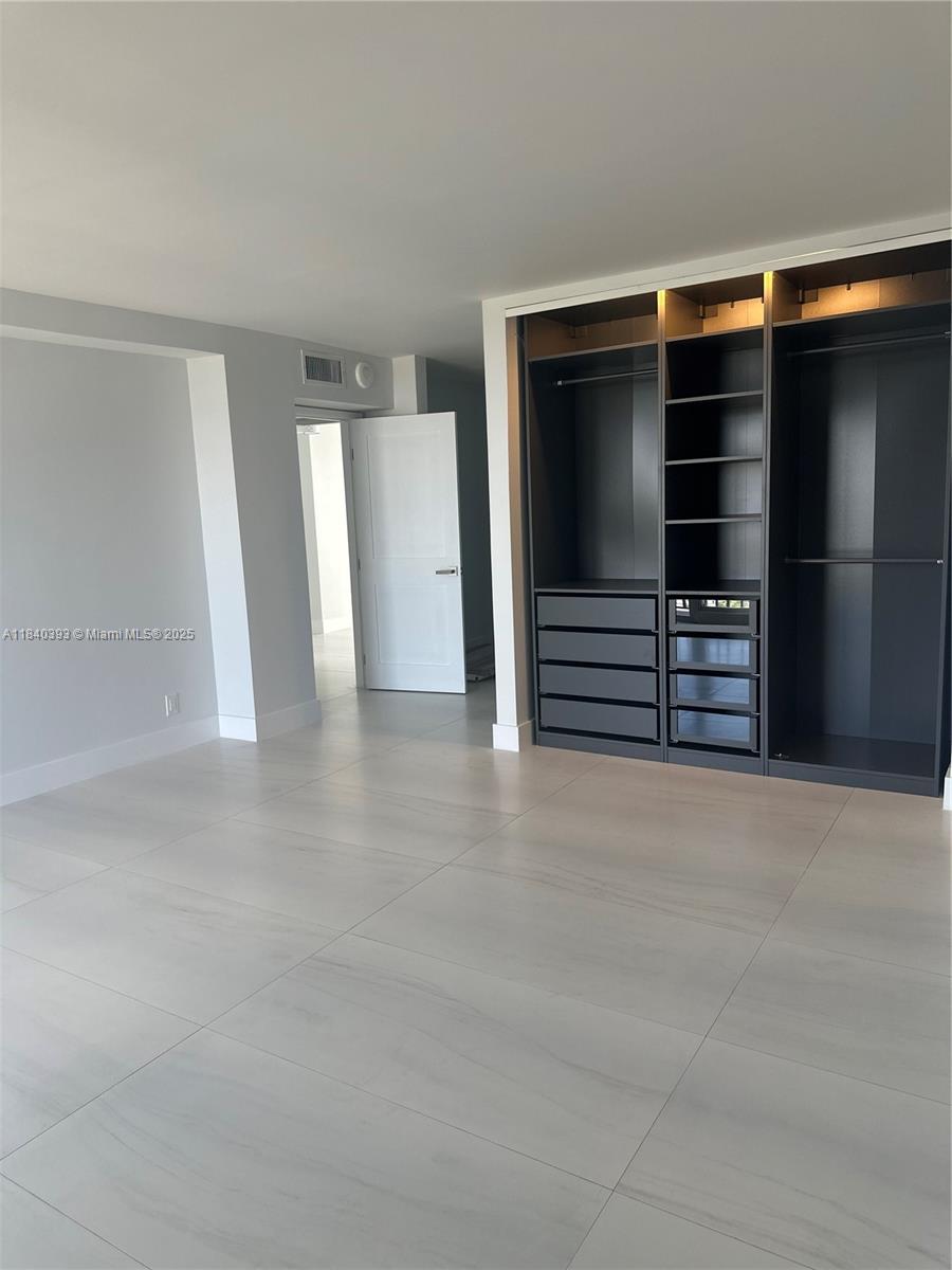 4280 Galt Ocean Drive, Unit 17C Fort Lauderdale, FL 33308 - Photo 16 of 16 a view of walk in closet with clothes and shoes