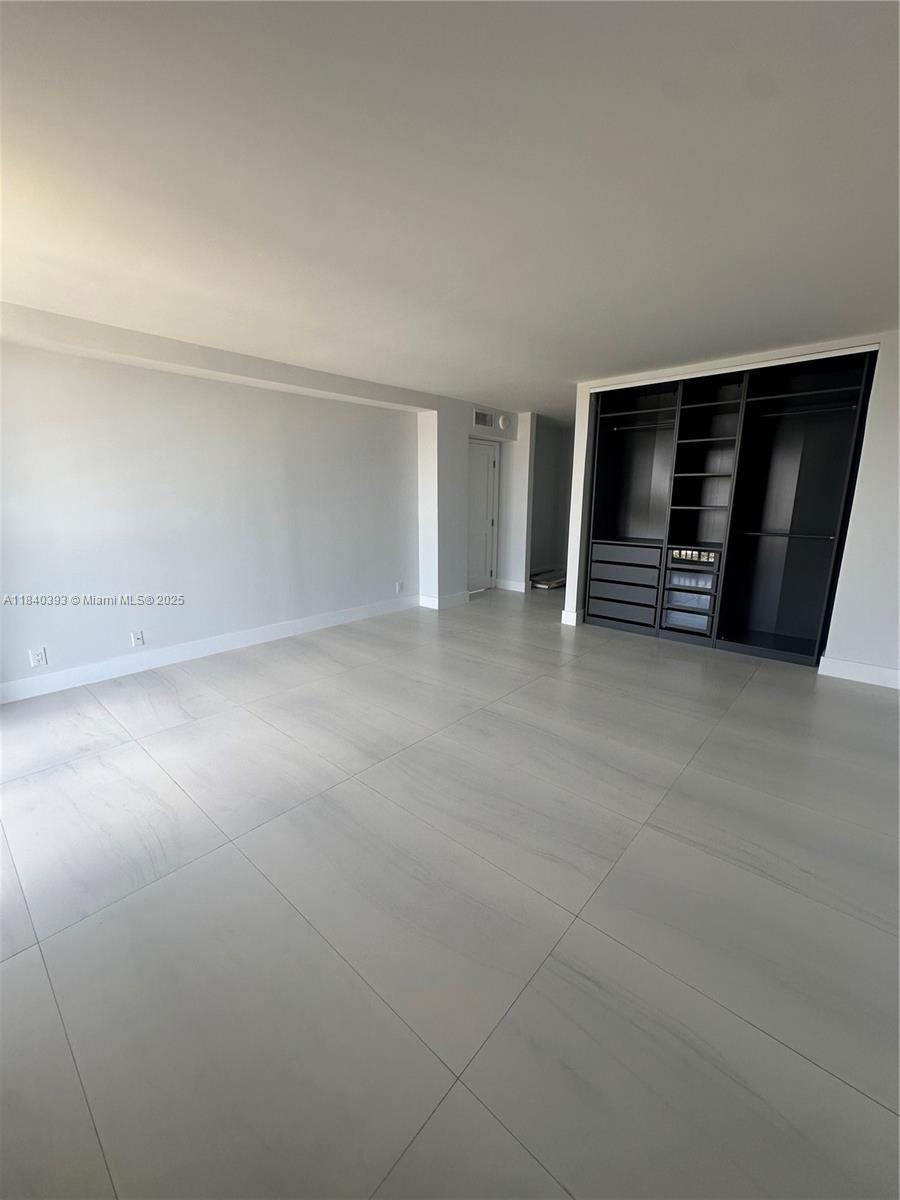 4280 Galt Ocean Drive, Unit 17C Fort Lauderdale, FL 33308 - Photo 4 of 16 an empty room with a fireplace and natural light