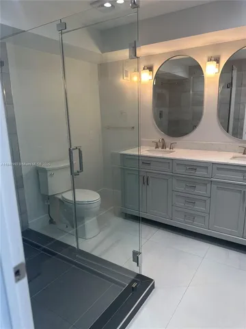 a bathroom with a double vanity sink and mirror