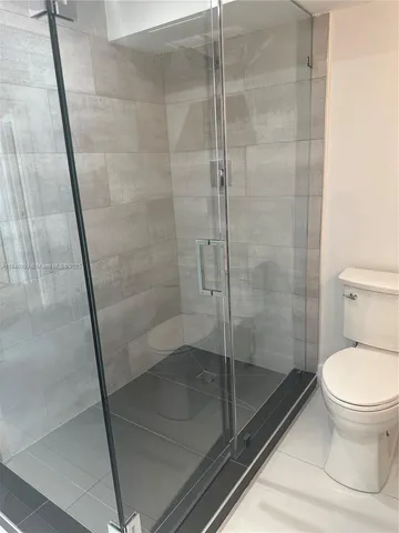 a bathroom with a shower and toilet