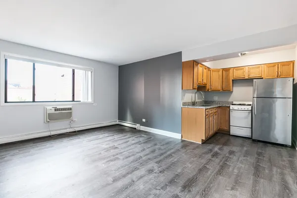 a kitchen with refrigerator cabinets and wooden floor