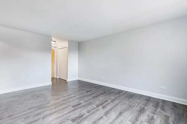 a view of an empty room and wooden floor