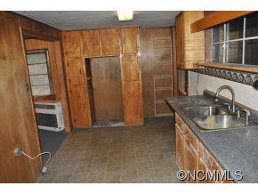208 Green Valley Road Waynesville, NC 28786 - Photo 9 of 15 a kitchen with stainless steel appliances granite countertop a sink and a refrigerator