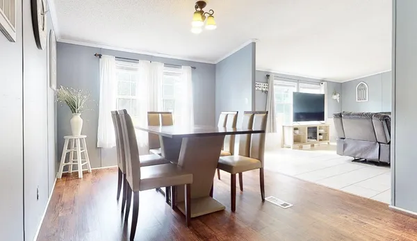 a view of a dining room with furniture window and wooden floor