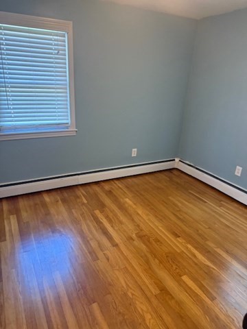 22 Forest Street, Unit 1 Ayer, MA 01432 - Photo 11 of 14 a view of empty room with wooden floor and fan