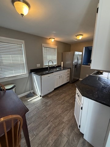 22 Forest Street, Unit 1 Ayer, MA 01432 - Photo 6 of 14 a kitchen with granite countertop a stove and a wooden floors