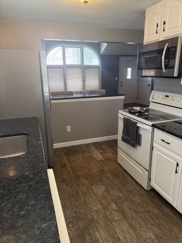 22 Forest Street, Unit 1 Ayer, MA 01432 - Photo 8 of 14 a kitchen with stainless steel appliances granite countertop a stove a microwave and a refrigerator