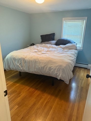 22 Forest Street, Unit 1 Ayer, MA 01432 - Photo 9 of 14 a bed sitting in a bedroom next to a window