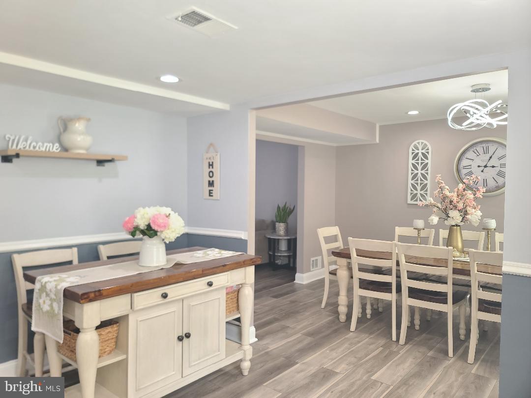 7834 Citadel Drive Severn, MD 21144 - Photo 11 of 58 a kitchen with stainless steel appliances cabinets and wooden floor