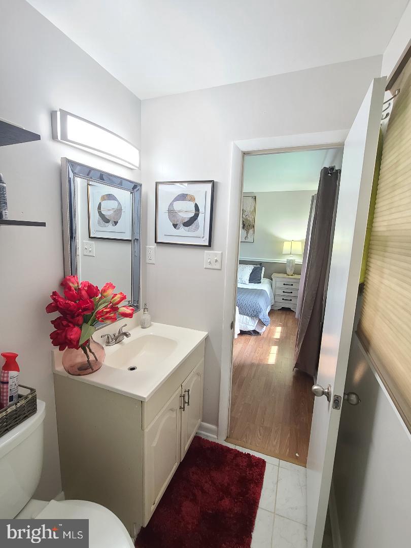 7834 Citadel Drive Severn, MD 21144 - Photo 21 of 58 a bathroom with a sink mirror vanity and toilet