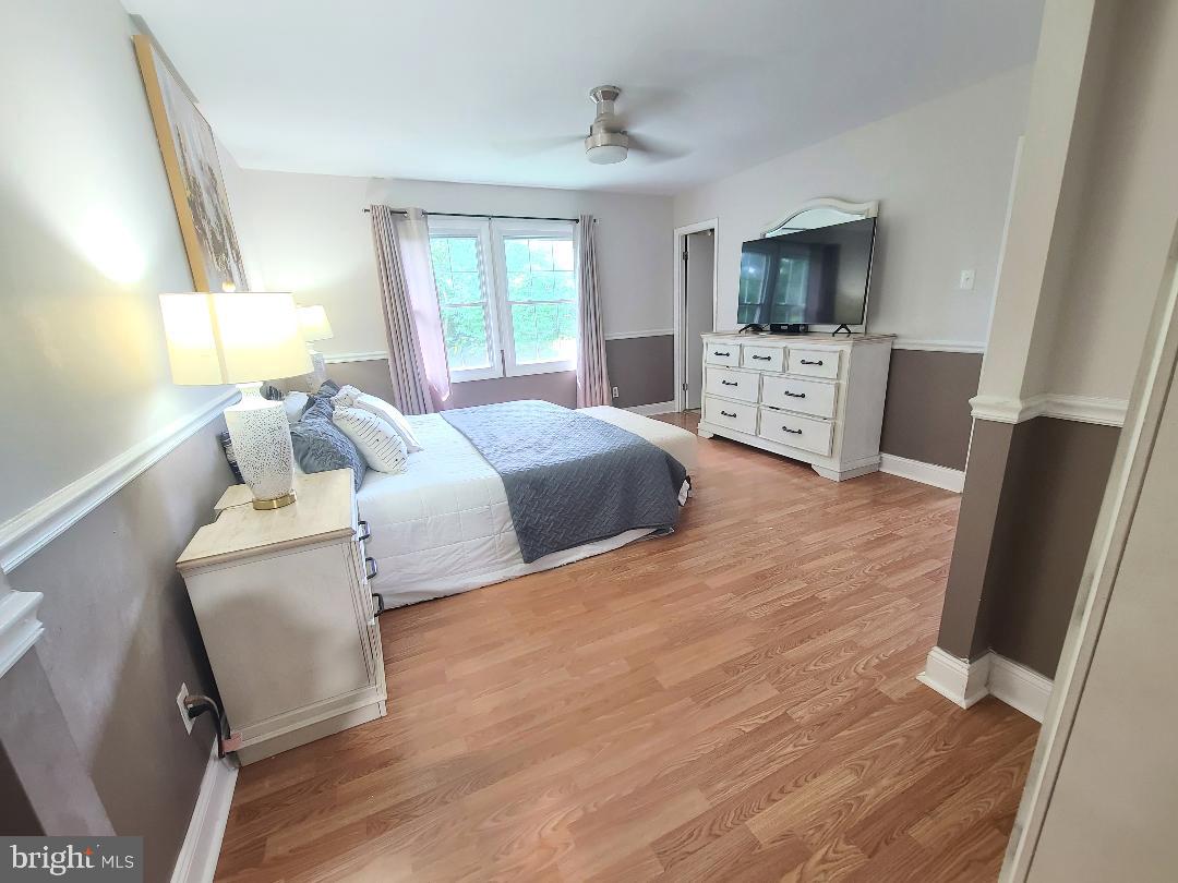 7834 Citadel Drive Severn, MD 21144 - Photo 24 of 58 a bedroom with a bed furniture and a flat screen tv