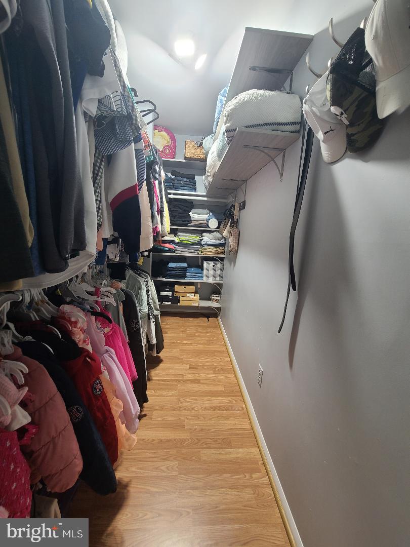 7834 Citadel Drive Severn, MD 21144 - Photo 25 of 58 a view of walk in closet with clothes and shoes