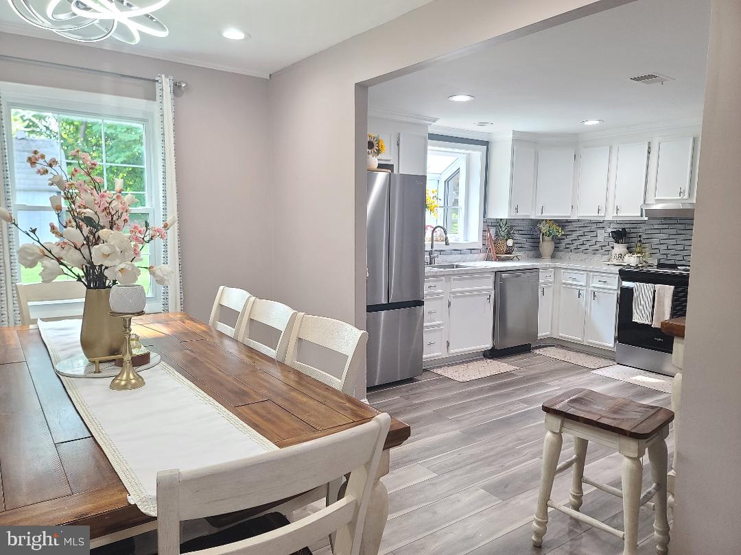 7834 Citadel Drive Severn, MD 21144 - Photo 40 of 58 a kitchen with stainless steel appliances granite countertop a stove refrigerator sink and dishwasher